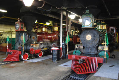 Two steam locomotives in a shop.