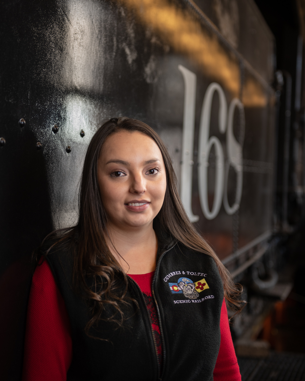 Young preservationist in front of a displayed historic railcar.