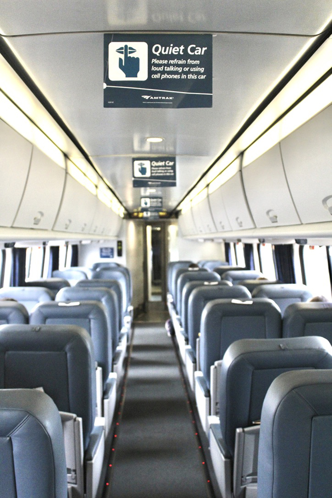 Inside of passenger car with "quiet car" signs
