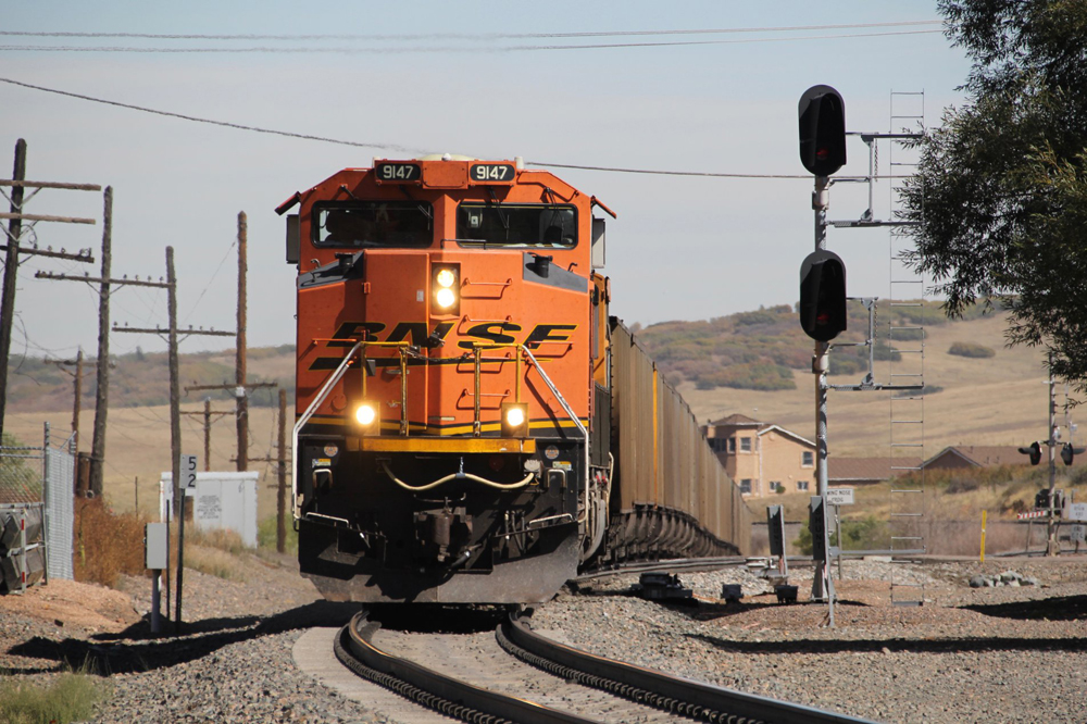 Orange locomotive and coal train