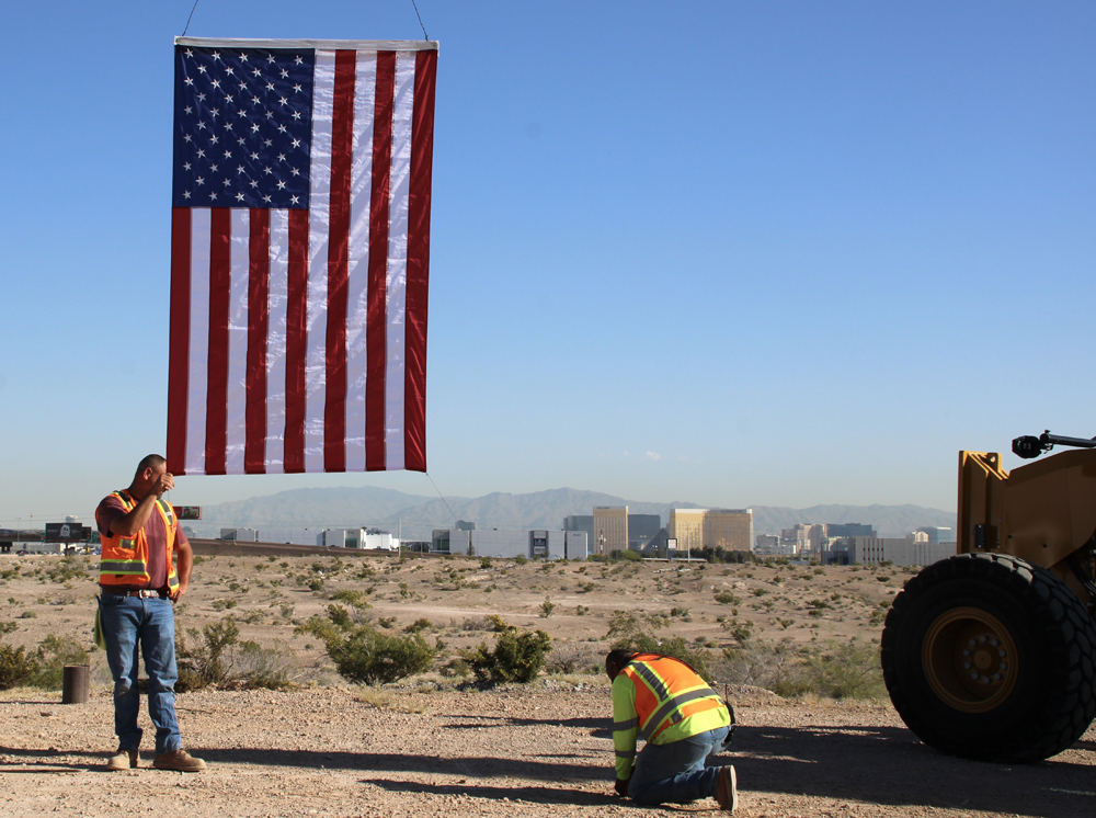 Men positioning American flag