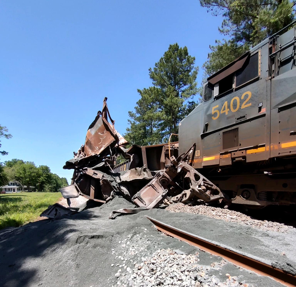 Locomotive and badly damaged railcar