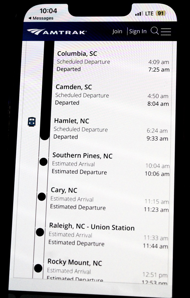 Passenger train schedule with delays as shown on cell phone