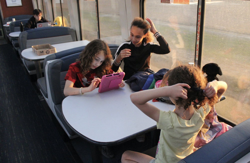 Three children at table in lounge