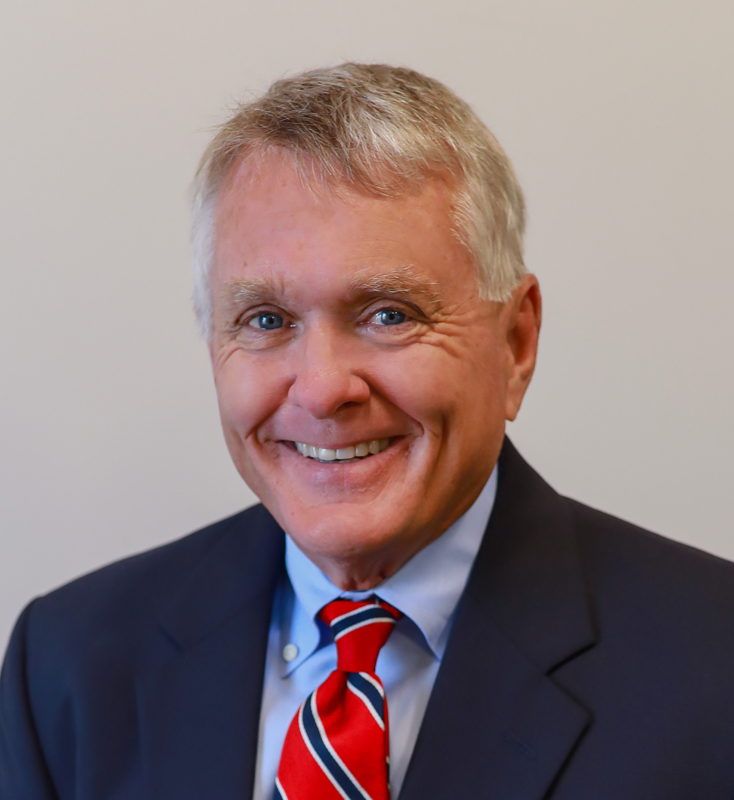 Smiling man in coat with red tie