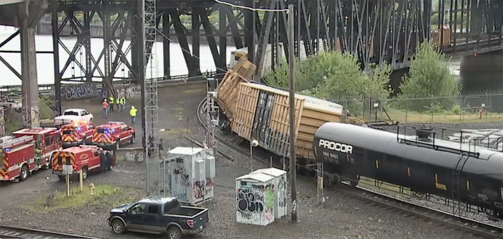 Derailed cars on curve leading onto bridge