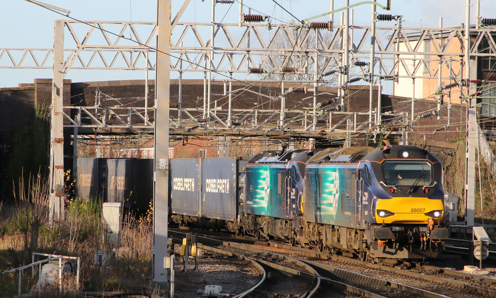 Two electric locomotives with freight train in Britain