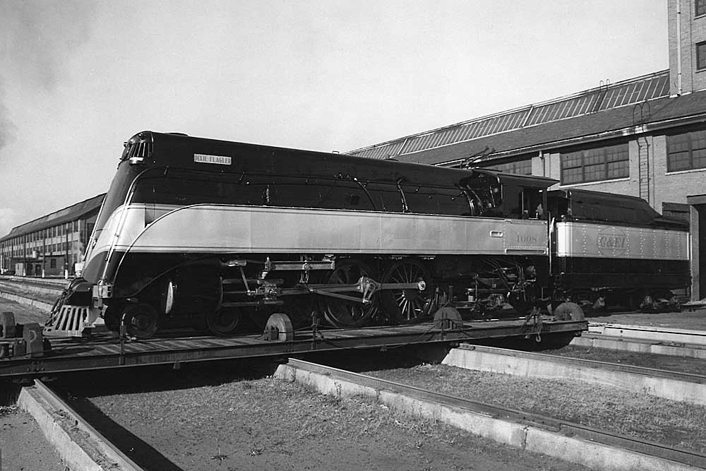 Streamlined steam Chicago & Eastern Illinois locomotives on transfer table outside of shop building