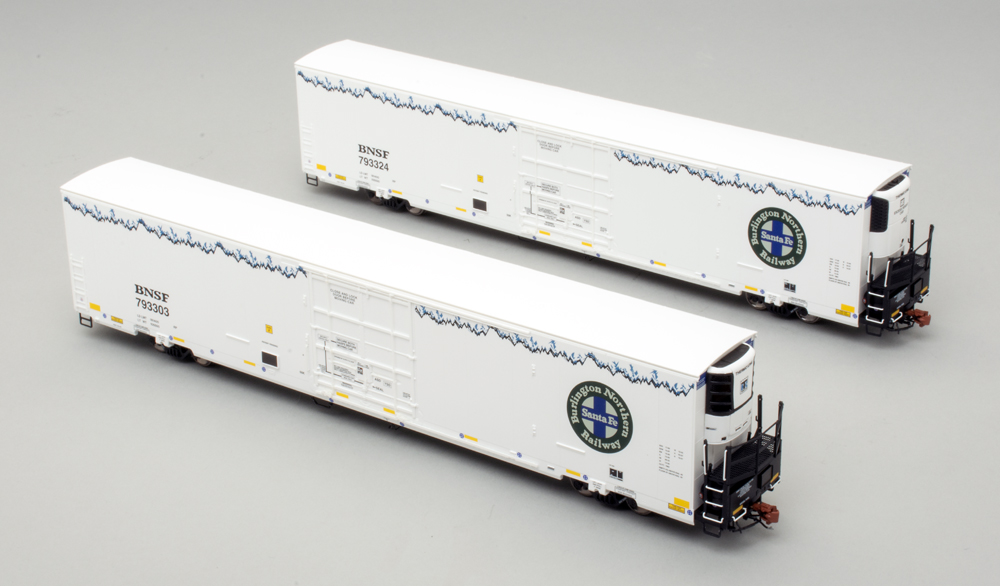 Color photo showing two HO scale refrigerator cars on gray background.
