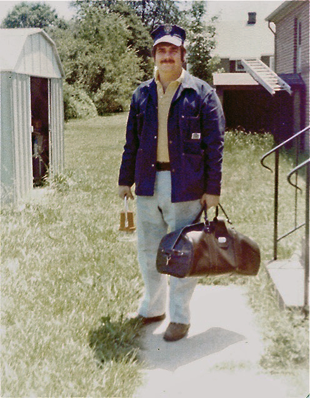 young man dressed to go to work carrying bag