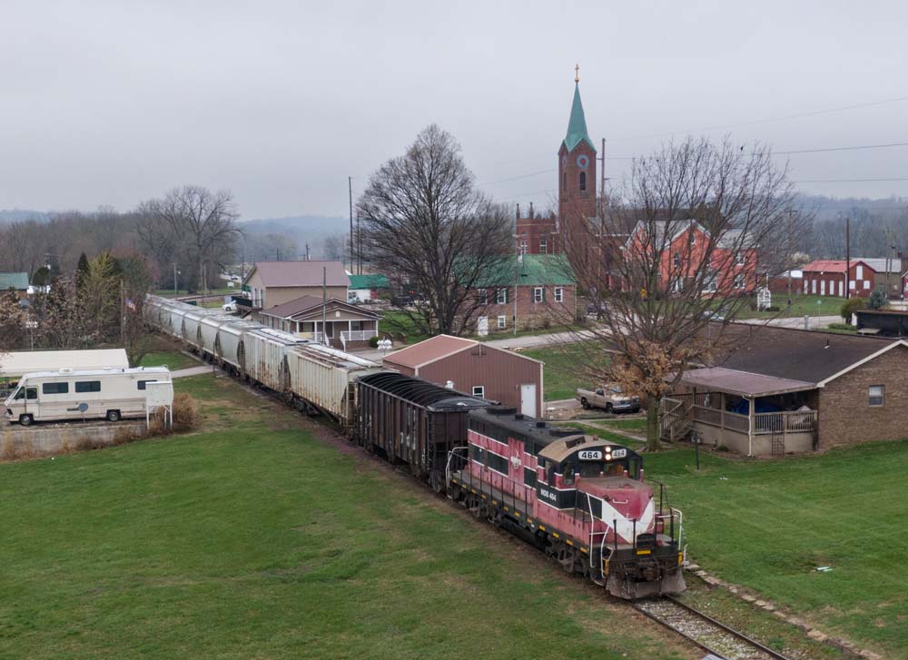 overcast day with locomotive passing through town