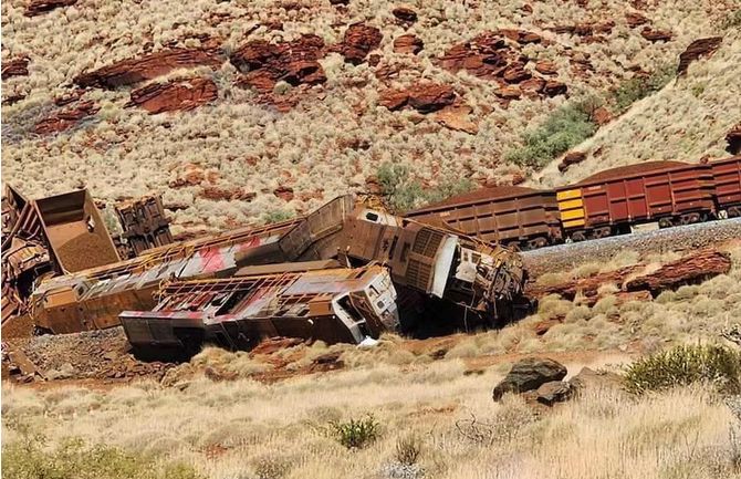 Badly damaged derailed locomotives and ore cars