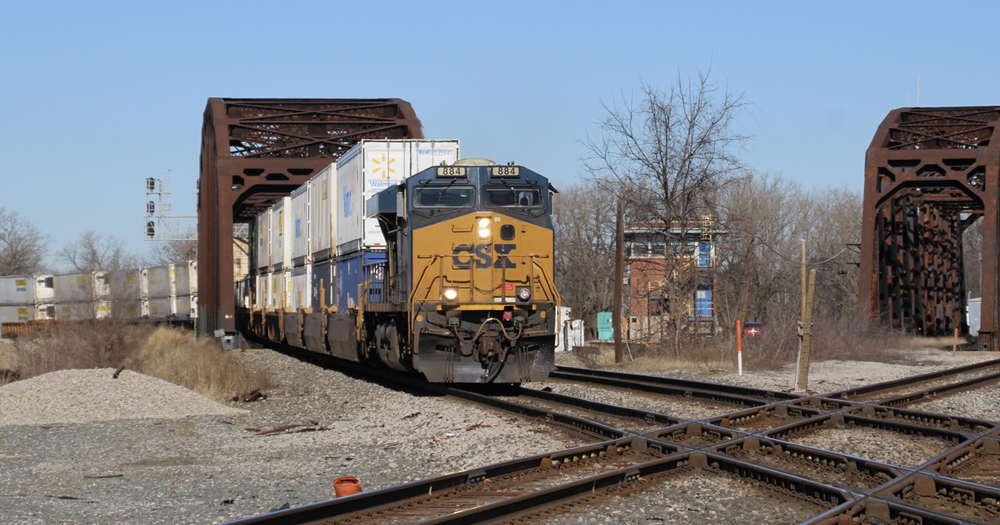 Intermodal train passing through steel girder bridge