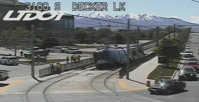 Image of derailed light trail train leaning to one side