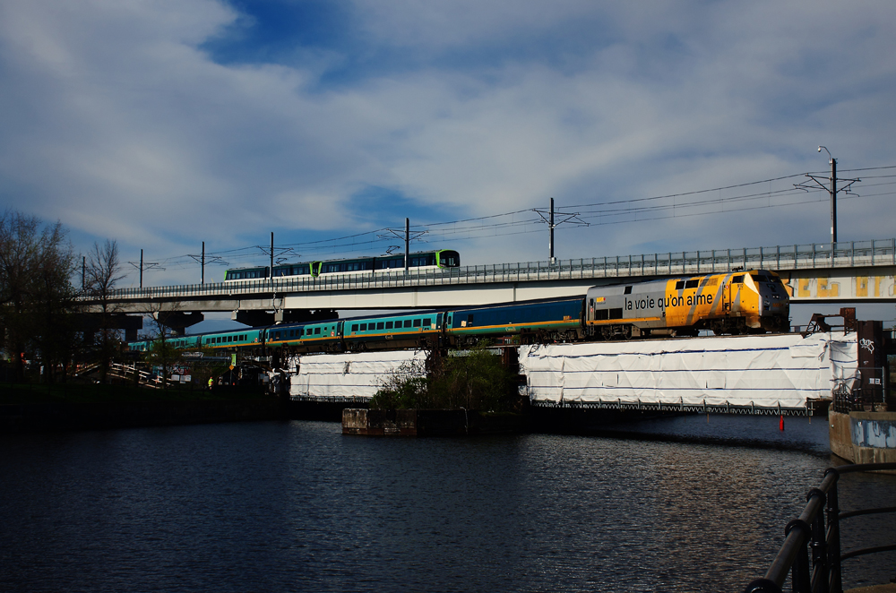 VIA Passenger train with British-built cars, with light-rail train in background