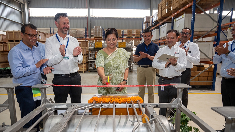 Woman cutting ribbon inside factory