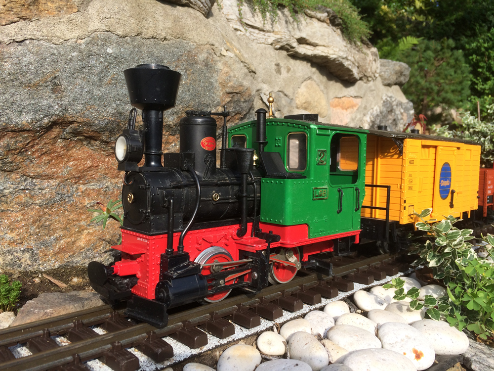 locomotive with boxcar on garden railroad