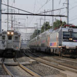 Commuter trains on two tracks of three-track line at station