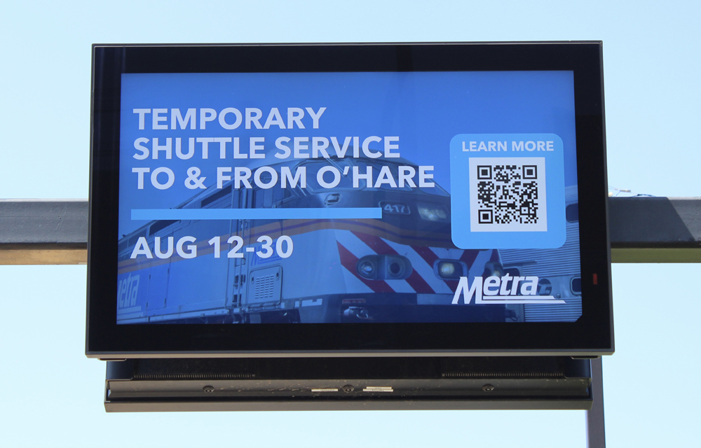 Video display board at station promoting O'Hare Shuttle service