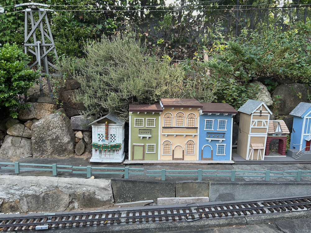 model city scene on garden railway with fence