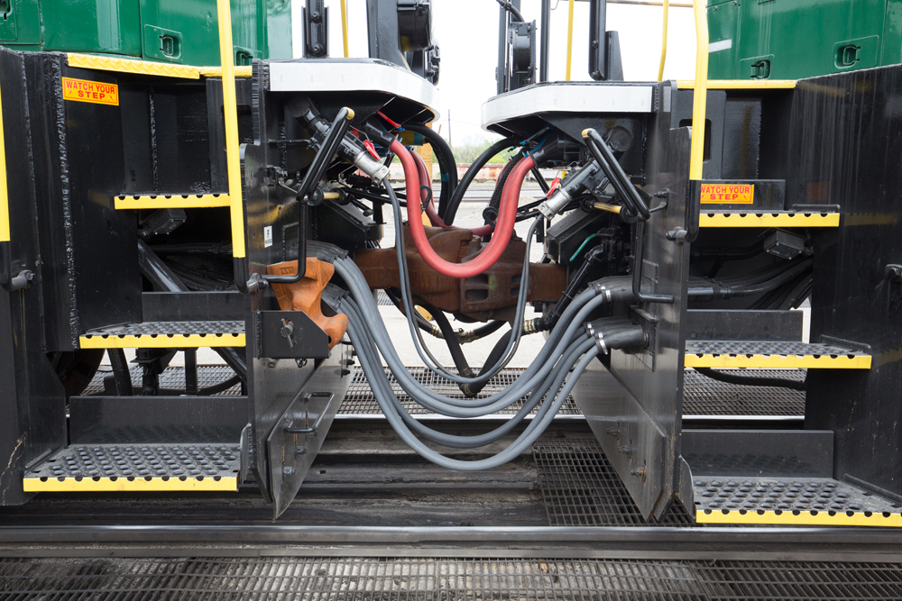 Side view of hoses and cables connecting a locomotive and slug unit