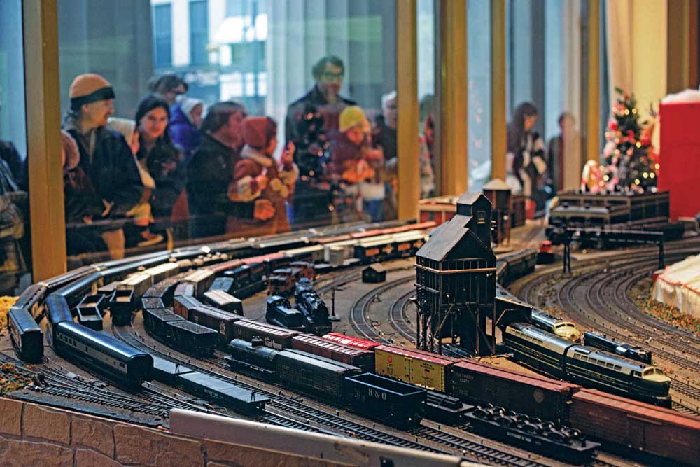 People stand around a Baltimore & Ohio toy train display in Cincinnati