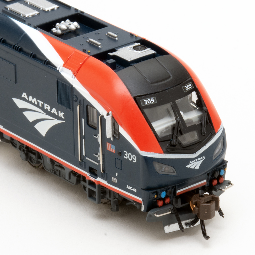 Color photo showing side view of streamlined N scale passenger locomotive.