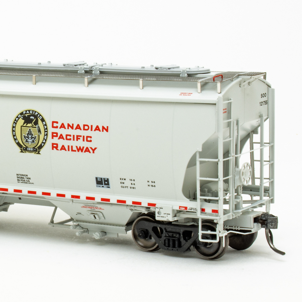 Color photo of HO scale covered hopper painted light gray on white background.