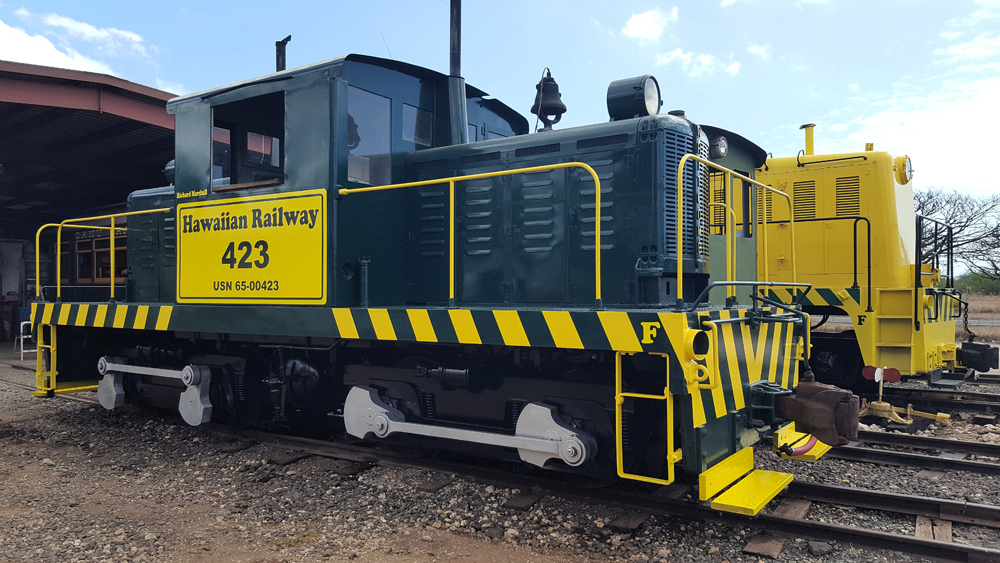 black and yellow center cab on track