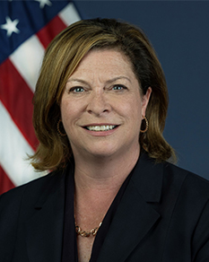 Head shot of woman standing in front of American flag