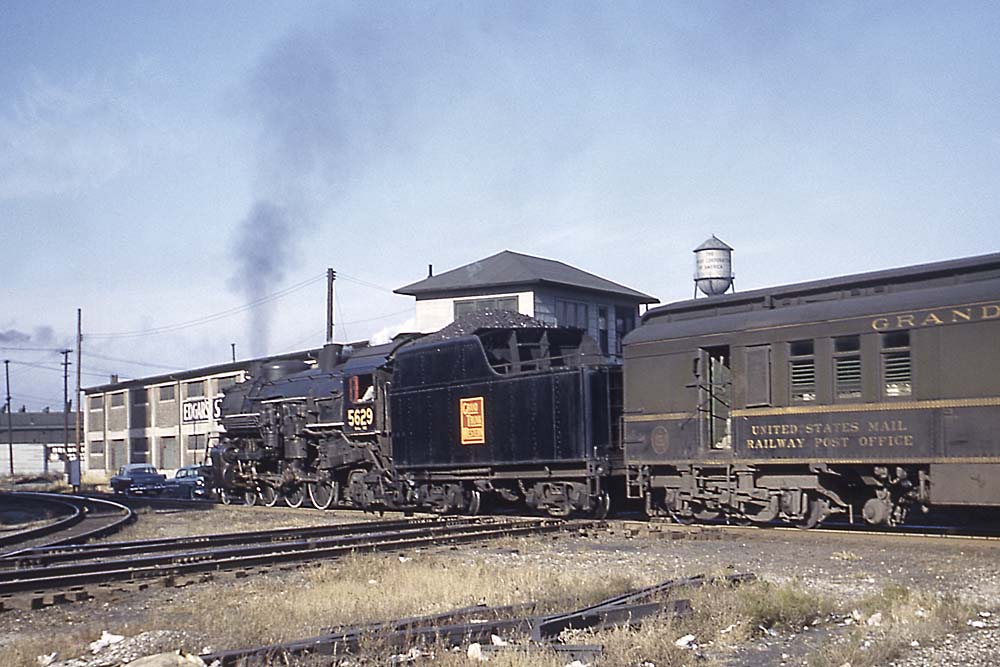 Grand Trunk Western steam locomotive with passenger train in city