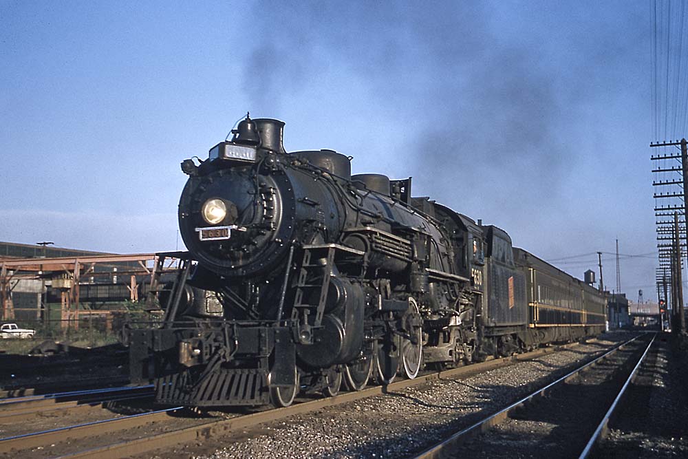 Grand Trunk Western steam locomotive with passenger train in city
