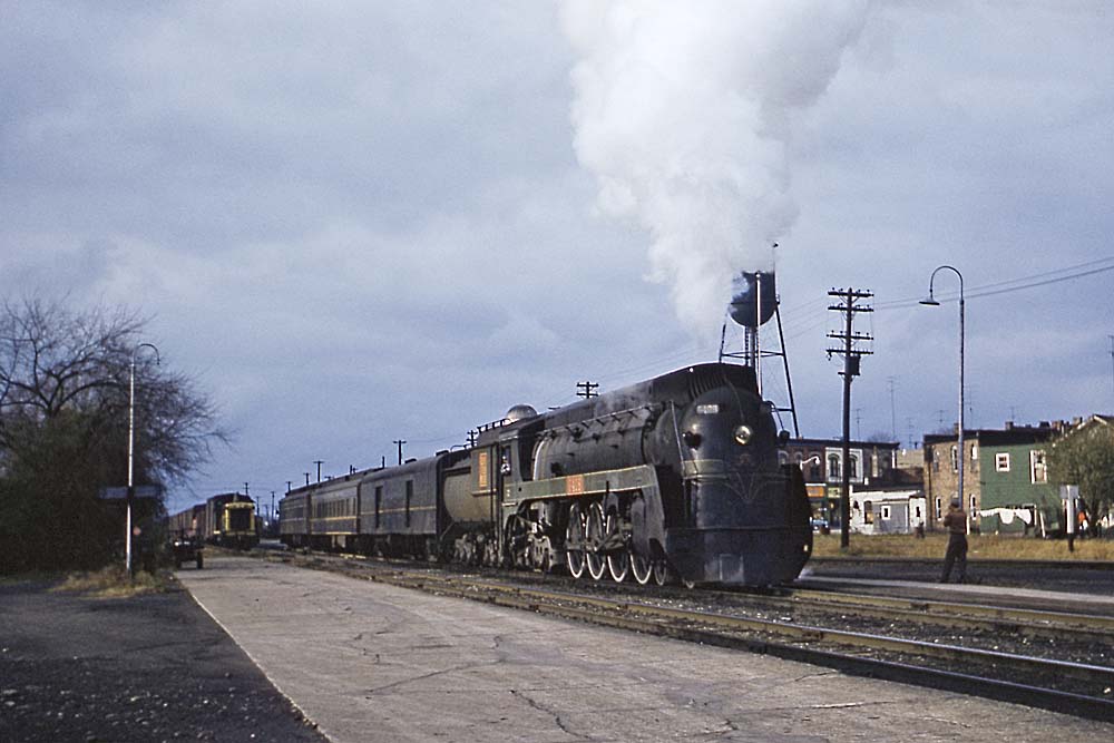 Streamlined Grand Trunk Western steam locomotive with passenger train at station