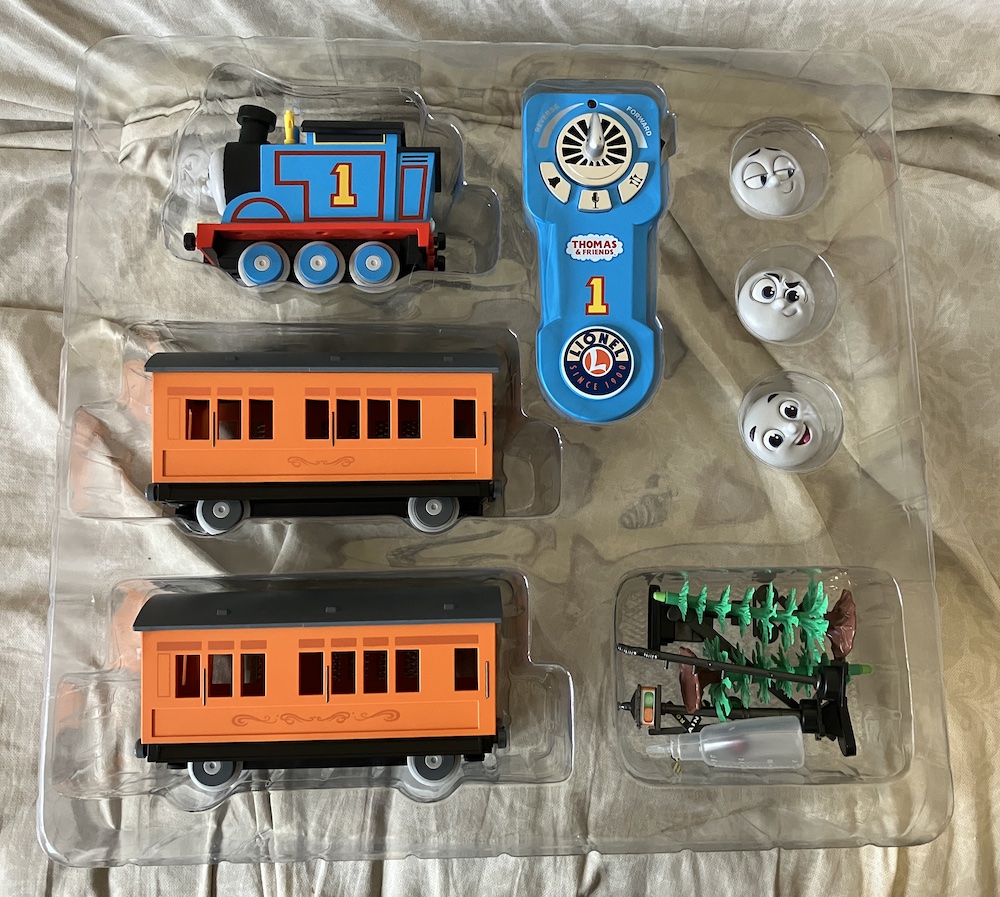 toy train set components in a plastic container; Lionel Thomas and Friends Battery Operated Train set