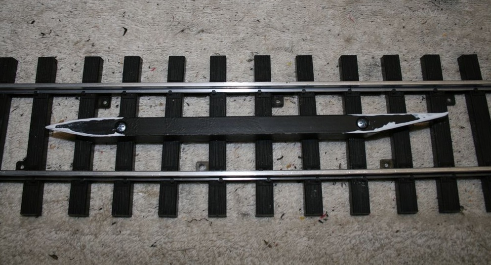 section of track with straight piece screwed onto middle