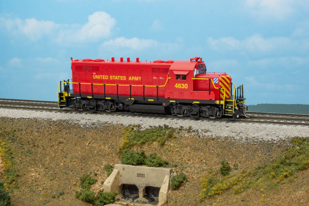 A red locomotive model with blue sky background