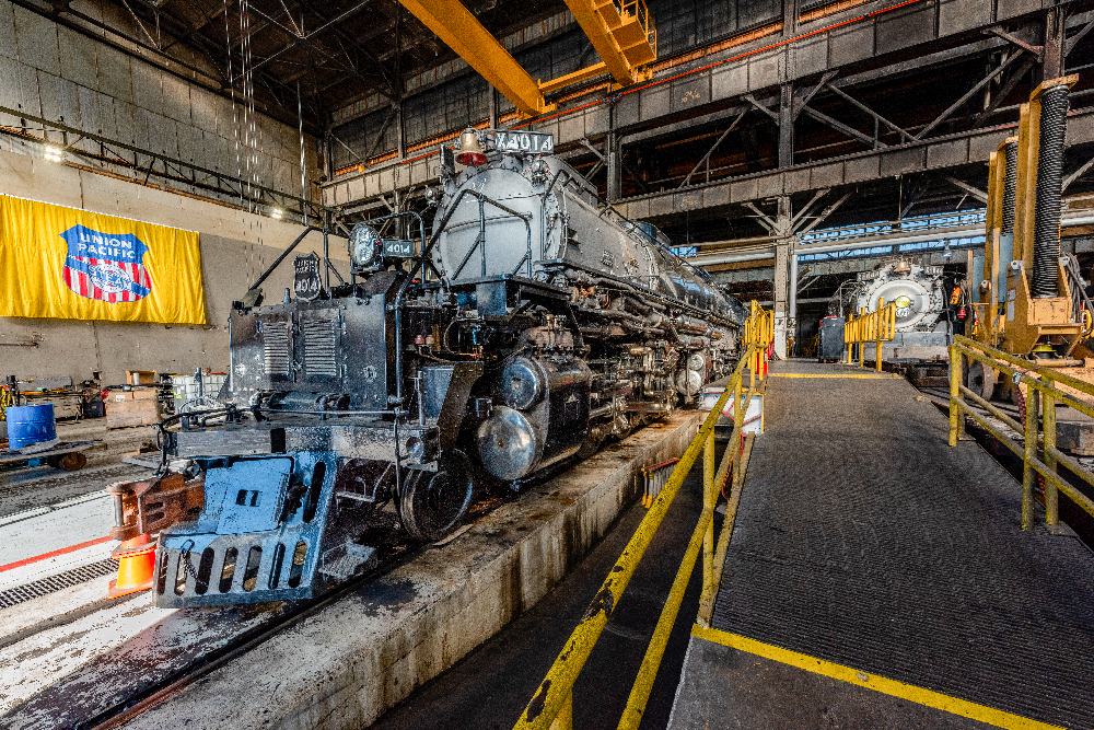 Big Boy steam locomotive inside shop building.
