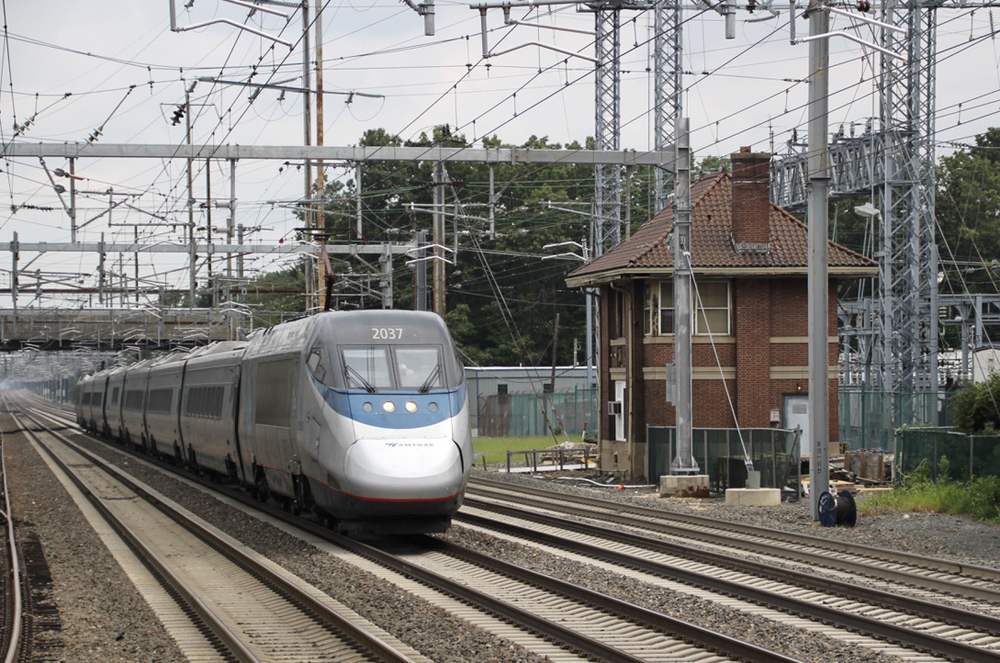 Streamlined high speed train passing brick tower