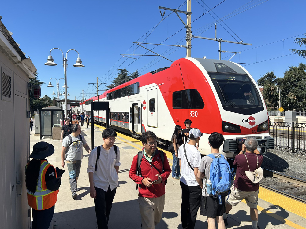 People on platform taking photos of new train