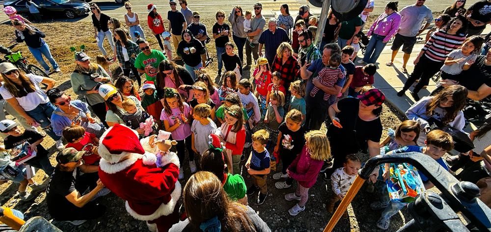 People surrounding Santa Claus
