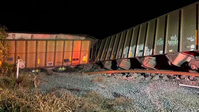 Derailed hopper cars at night