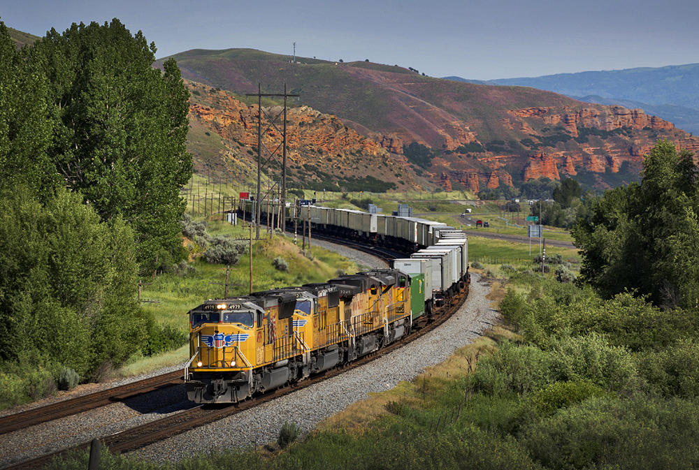 Train with yellow locomotives in Utah mountains