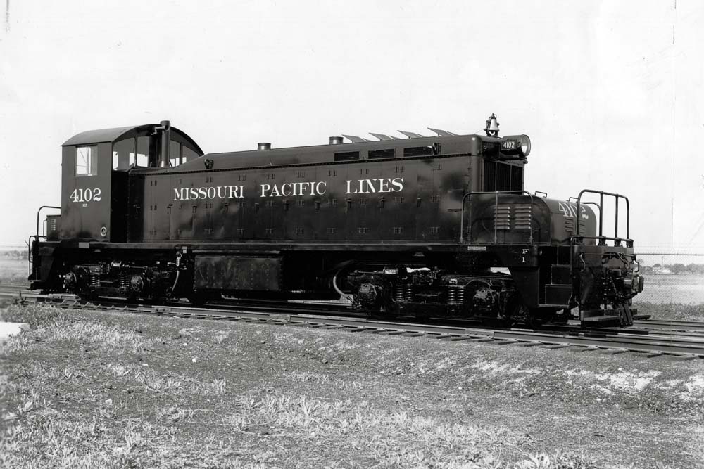 Black end-cab diesel locomotive in empty rail yard