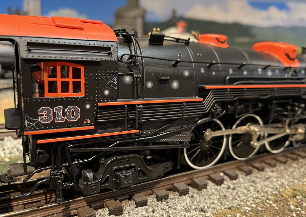 close up of red and black model steam locomotive