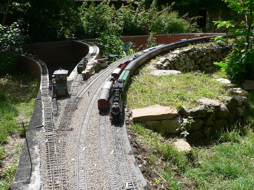 long train on curve of garden railroad