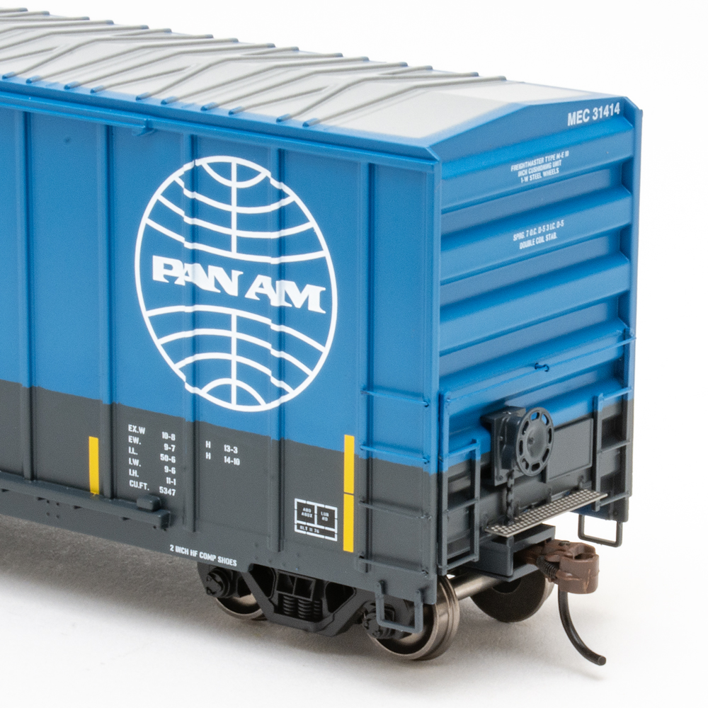 Photo of HO scale boxcar in blue and gray paint on white background.