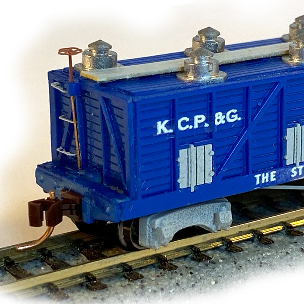 Color photo of N scale freight car painted blue with silver and gray details.