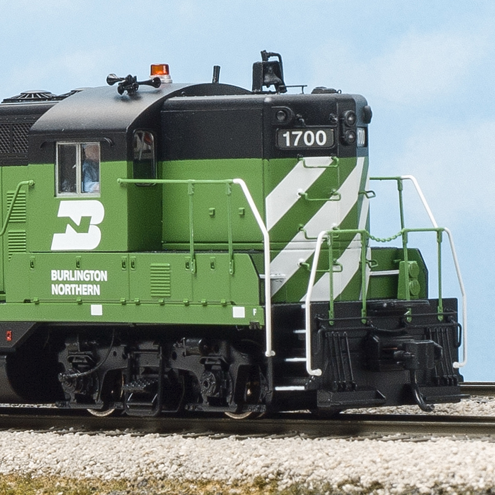 Color photo of two HO scale diesels in green and black paint.
