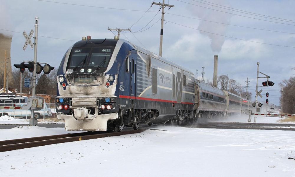 Passenger train crossing diamond in snow