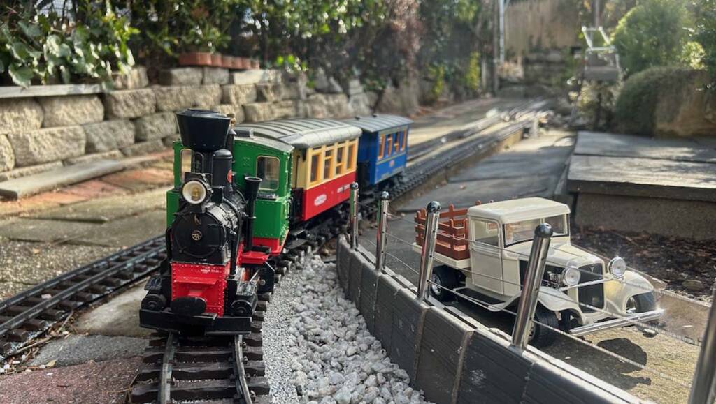 A garden railroad layout with a you steam locomotive